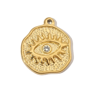 Detail view of a gold hammered stainless steel evil eye pendant with a central rhinestone