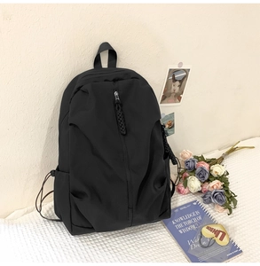 Macro shot of durable black nylon backpack material with side pocket and zipper detail