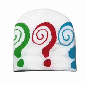 Detailed view of the white knitted beanie featuring colorful jacquard swirl patterns