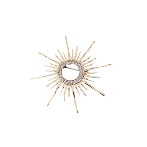 Vintage gold plated sunburst brooch featuring a zircon-encrusted center on white background
