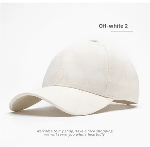 Detail view of off-white baseball cap showing diamond quilted pattern and classic 6-panel structure
