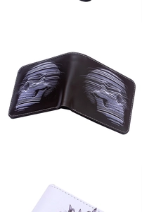 Close-up of black bifold wallet with glitch style white skull print and white stitching