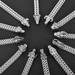 Detailed macro view of vintage zodiac metal charms in silver-tone for woven bracelets