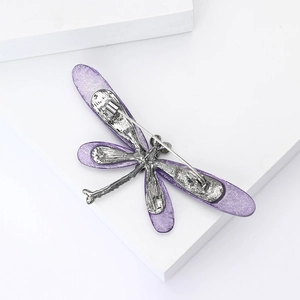 Detail of the silver dragonfly brooch back featuring a secure pin and purple wings