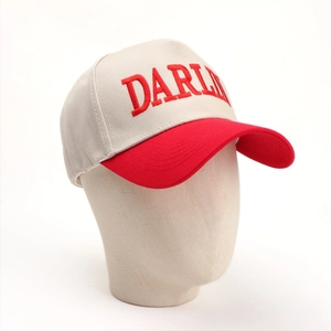 Detailed close-up of 3D Darling embroidery on a two-tone cotton baseball cap with red brim