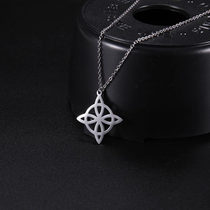 Detailed close-up of a silver Celtic knot pendant necklace with high-polish finish
