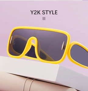 Y2K style bright yellow square frame sunglasses displayed on a modern geometric stand