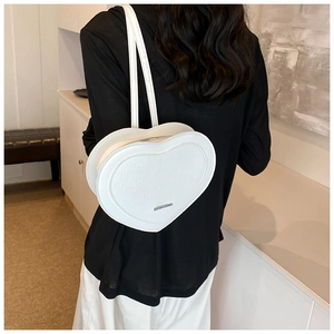 White heart-shaped PU leather backpack featuring embossed texture and slim shoulder straps