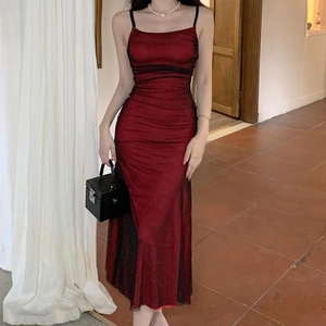 Detailed view of dark red bodycon dress with pleated texture and adjustable straps
