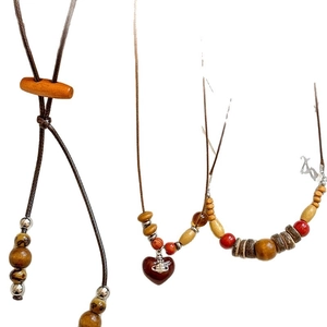 Vintage bohemian coconut wood bead necklaces with heart pendant on a white background