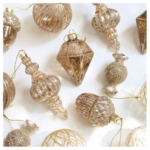 Detail of champagne gold Christmas ornaments with glitter, matte and glossy finishes