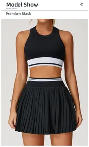 Detail of premium black seamless yoga top and pleated skirt with striped elastic waistband