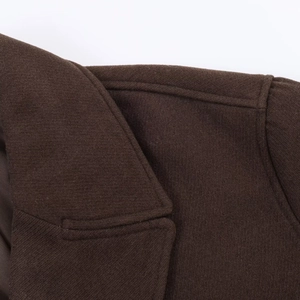 Detail shot of fabric texture and high-quality stitching on brown wool coat collar