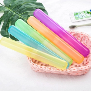 Five colorful portable travel toothbrush storage cases in a decorative basket