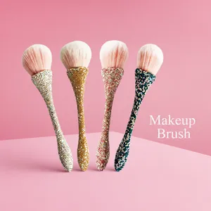 Detail of ergonomic diamond studded makeup brush handles in gold and silver finishes