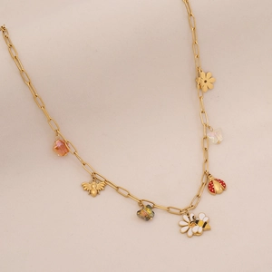 Detail of gold paperclip chain necklace with colorful crystal bee and ladybug charms