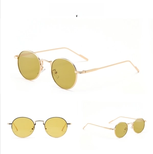 Detailed view of retro small round sunglasses with gold metal frame and green lenses