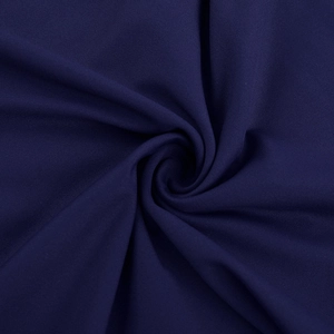 Macro view of high-density navy blue woven fabric with elegant spiral draping detail