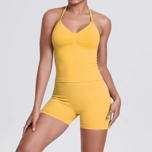 Detail of ginger yellow seamless yoga set featuring halter neck bra and high waist shorts
