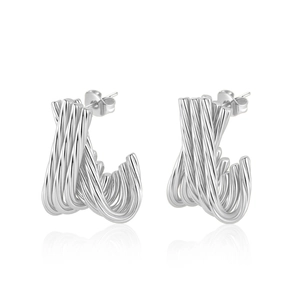 Detailed macro view of silver twisted U-shaped stainless steel earrings on white background