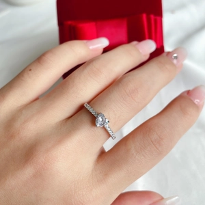 Close-up of S925 sterling silver ring with heart-shaped pink zircon worn on finger