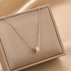 Elegant gold titanium steel necklace with sparkling crystal cylinder pendant on silk