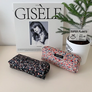 Detail of floral corduroy pouches in navy and cream with merciparis woven label