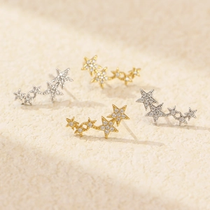 Star-shaped S925 silver stud earrings with crystals in gold and silver finishes