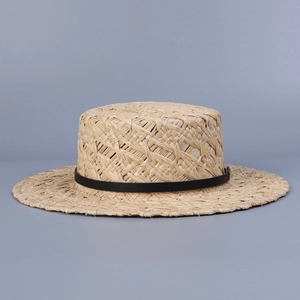 Detail of hand-woven natural raffia boater hat with black ribbon band and flat top