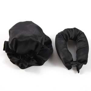 Detail of black satin heatless hair curler set and hair bonnet on white background