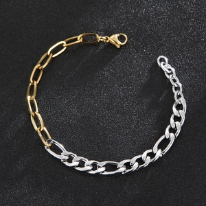 Detail of two-tone gold and silver Figaro chain bracelet with lobster clasp closure