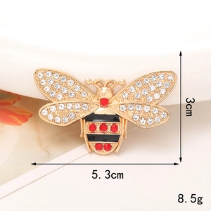 Detail of bee accessory with size markers 5.3cm x 3cm and gold plating with rhinestones