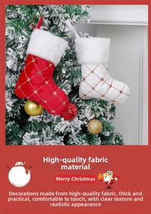 Detail of red and white quilted Christmas stockings with gold sequins on a snow tree