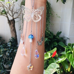 Detailed silver butterfly suncatcher with crystal drops and a blue mushroom pendant charm