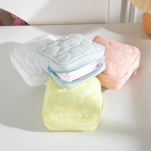 Quilted cream-colored cloud makeup bags in four pastel colors for travel storage