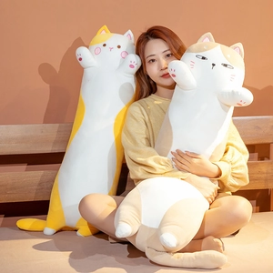 Detailed view of long plush cat pillows in yellow and brown with soft fabric texture