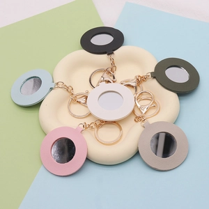 Group of colorful PU leather heart mirror keychains with gold metal rings and lobster clasps