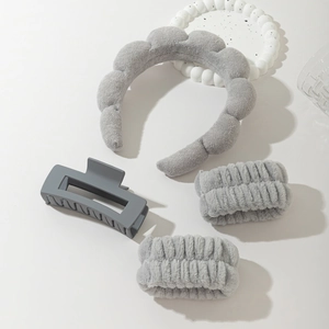 Detail showing grey sponge headband, matching wristbands, and matte hair claw set