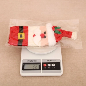 Kitchen scale displaying the 32g weight of a knitted Santa wine bottle cover