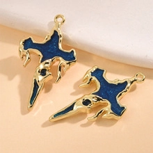 Detail of vintage gold melting cross pendant with dark blue enamel inlay and hanging ring