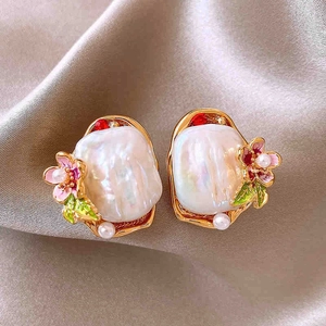 Detail view of pearl bouquet earrings with pink flowers on champagne silk fabric