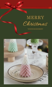 Detailed view of pink and white gradient Christmas tree candle with leaf textures