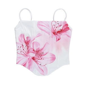 Detailed view of pink lily floral print and corset-style boning on white summer top