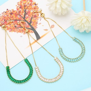 Detailed view of adjustable gold-plated bracelets with baguette-cut zircon in three colors