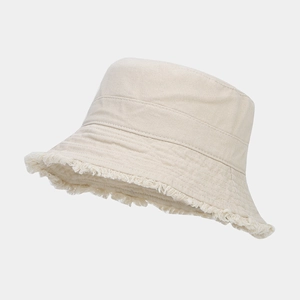 Close-up of beige canvas bucket hat featuring a vintage frayed edge and twill texture