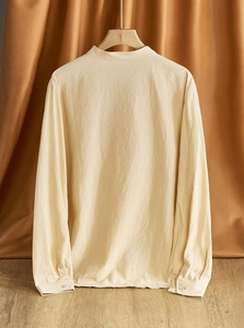 Detail view of the beige linen shirt back showing high-quality fabric texture on a wooden hanger