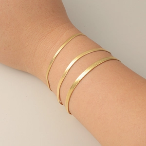 Set of three gold-plated stainless steel flat snake chain bracelets in various widths