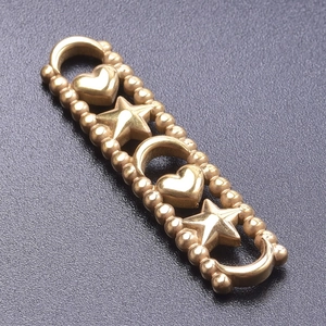 Macro view of gold stainless steel heart and star connector for DIY jewelry making