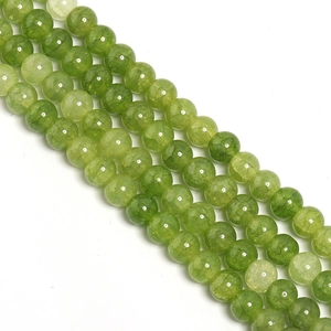 Macro detail of round light green glass beads with natural ice crack texture for DIY jewelry