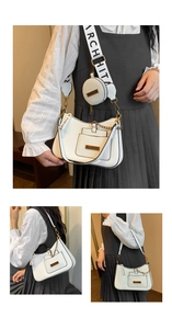 Detailed view of white lychee leather hobo bag with round coin purse and wide strap